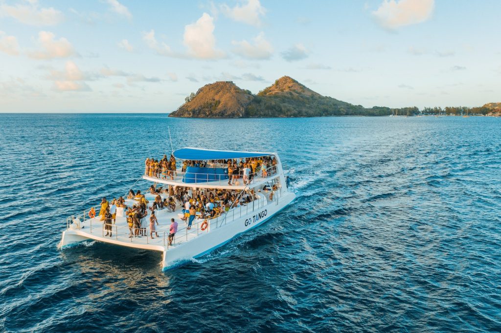 people riding on a white boat on the sea during daytime